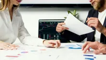 Two people at a desk with papers