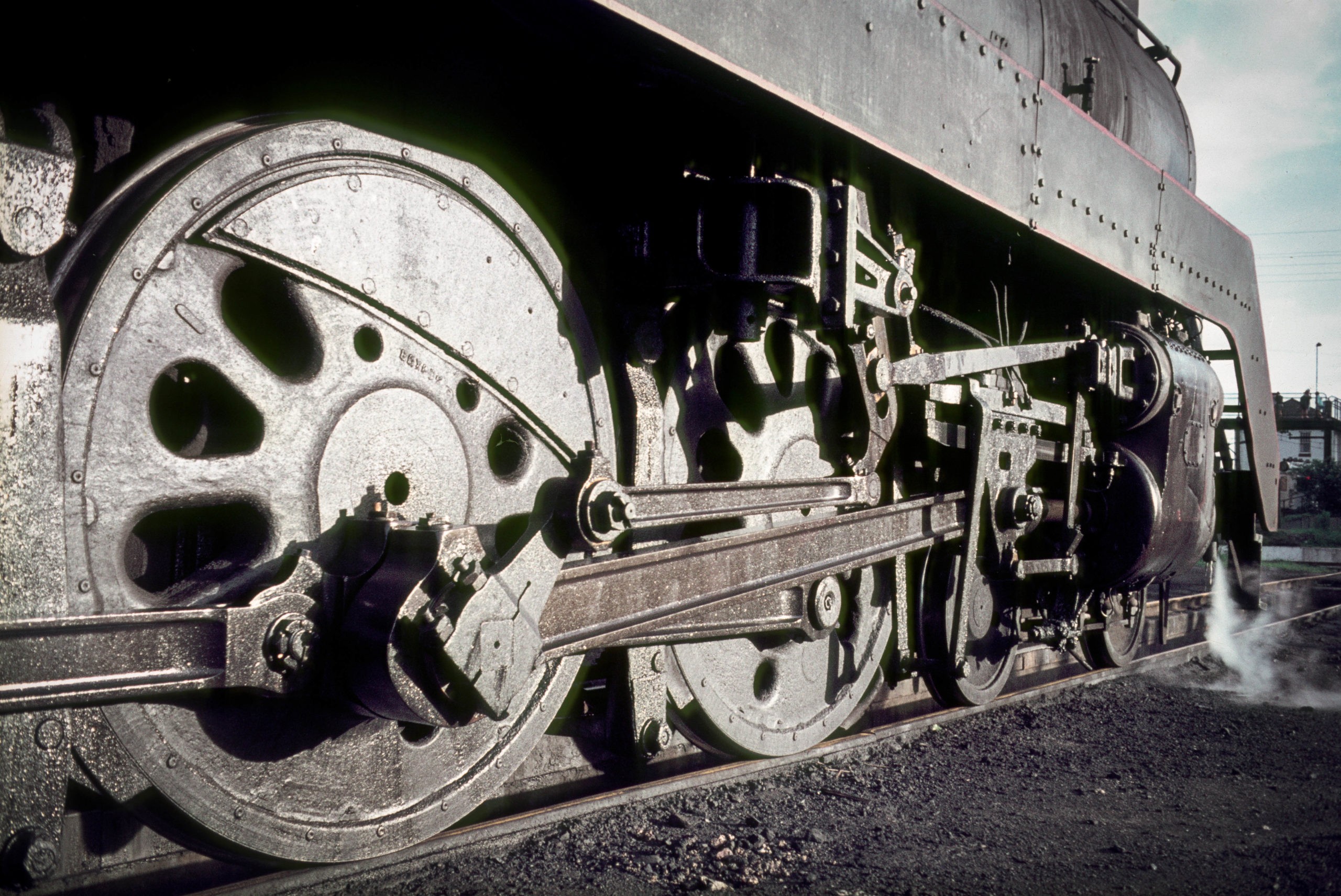 A close-up photo of an old train's wheels on a train track