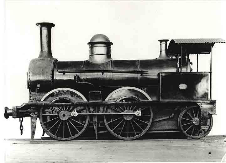 A black and white photo of an old steam train